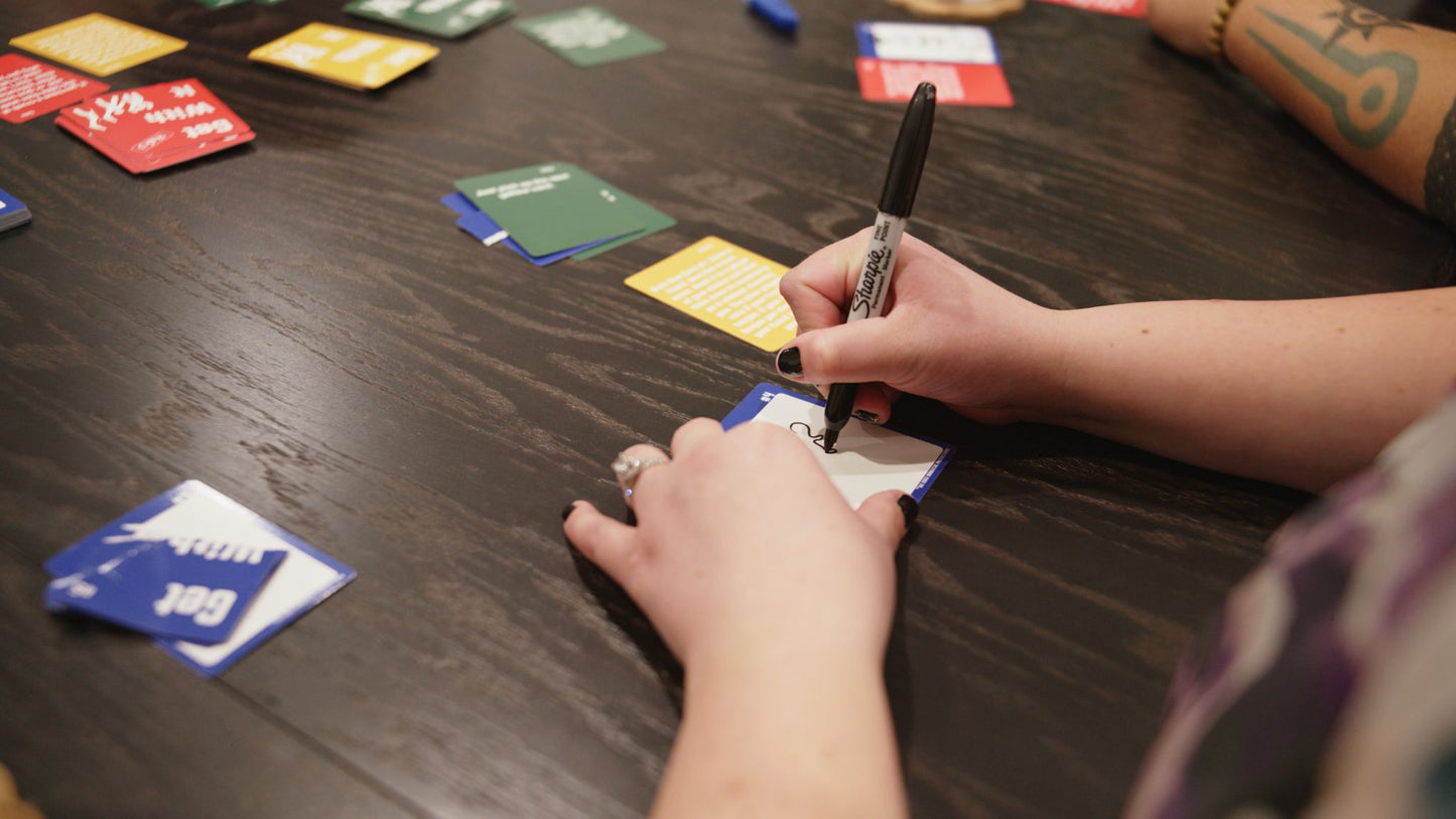 A woman drawing a picture for the game Get With It