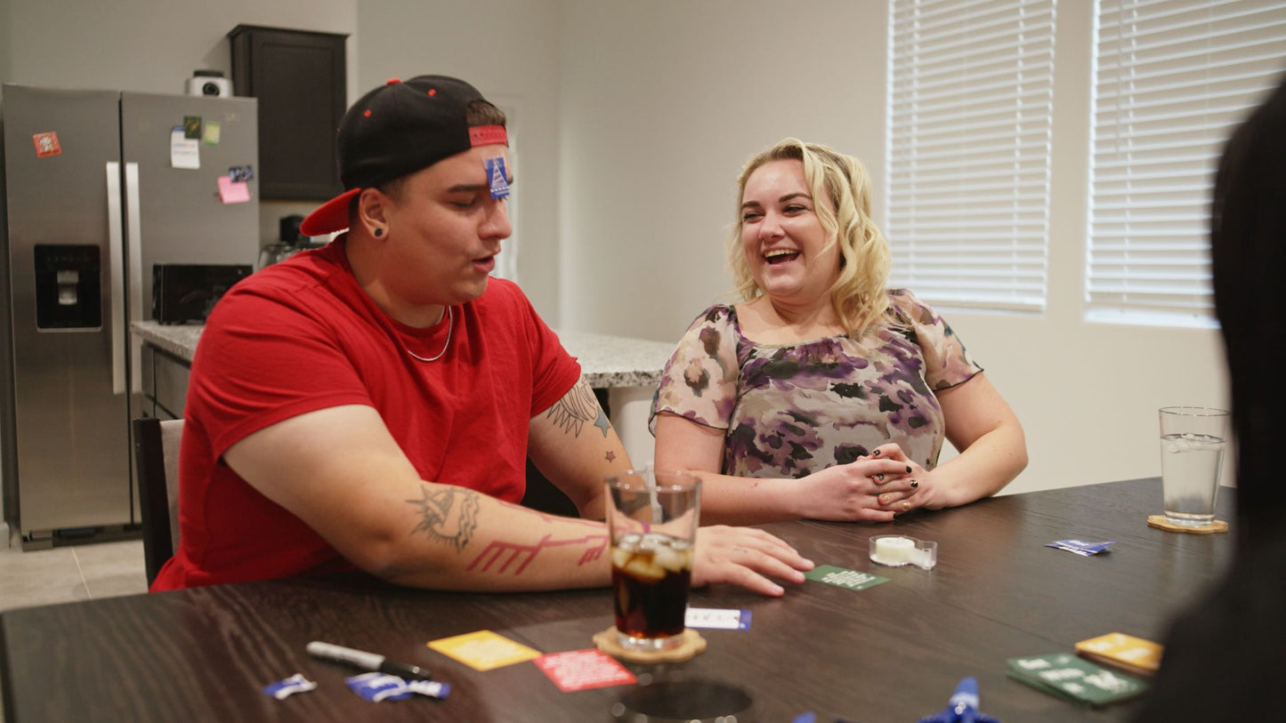 A lovely couple playing get with it. The blonde woman is laughing at the goofy antics her husband has to do.