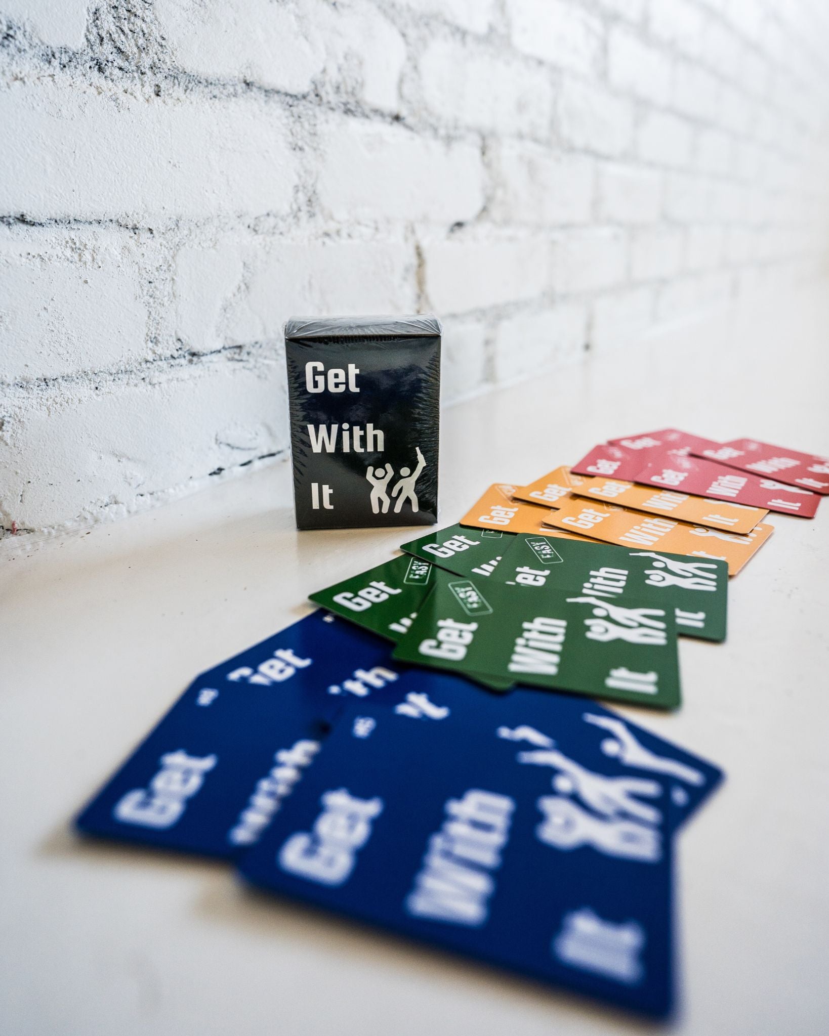 Get With It product image showing action and challenge cards, easy, medium, and hard